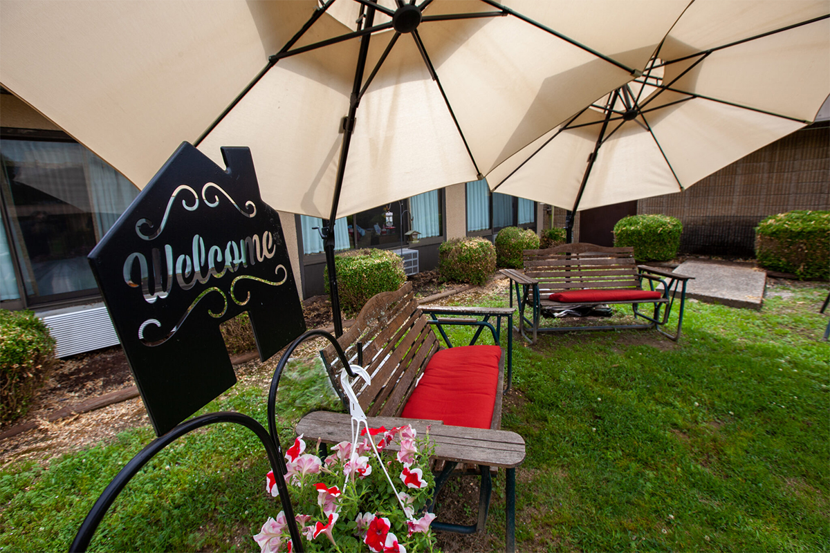 Outdoor patio with welcome sign.